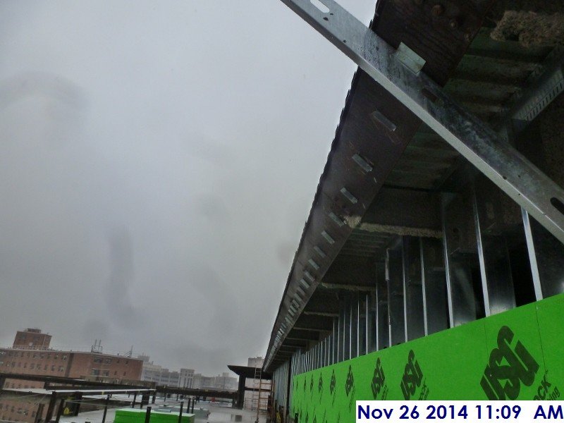 Installed metal clips along the top roof perimeter for the parapet Facing East